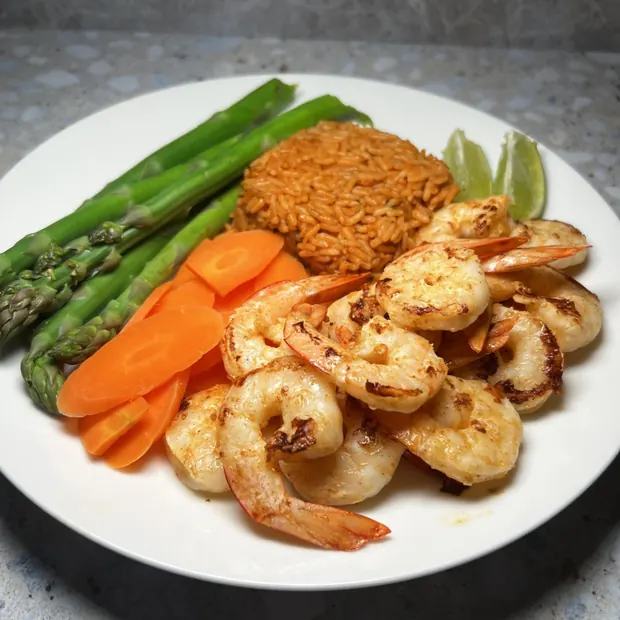 Grilled prawns with rice, asparagus and carrots